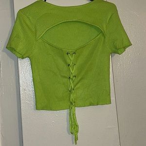 A neon green opened chest knitted crop (top piece)